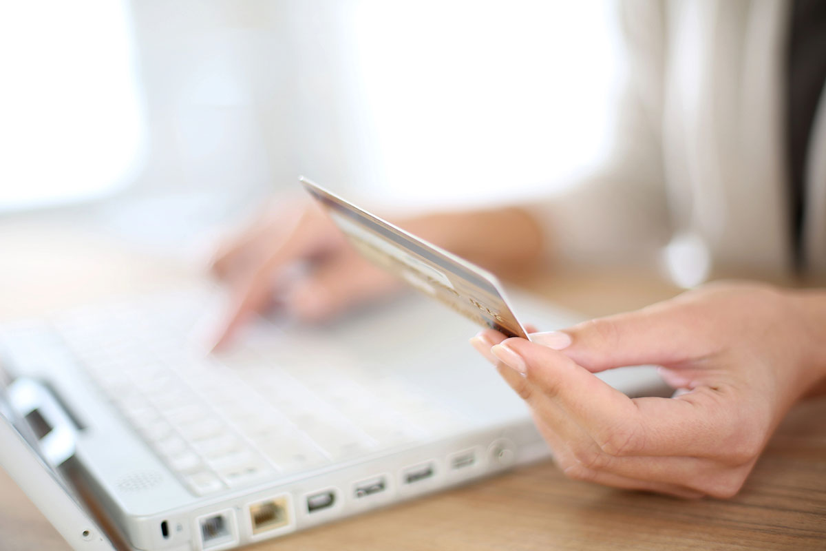 Woman holding a travel credit card.
