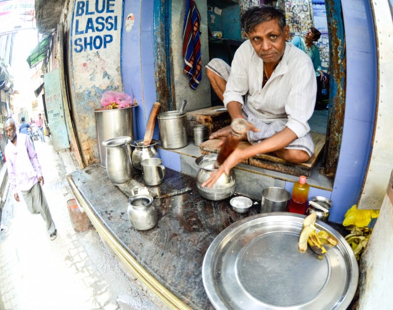 Man making yogurt lassi drinks at the Blue Lassi Shop in Varanasi, India