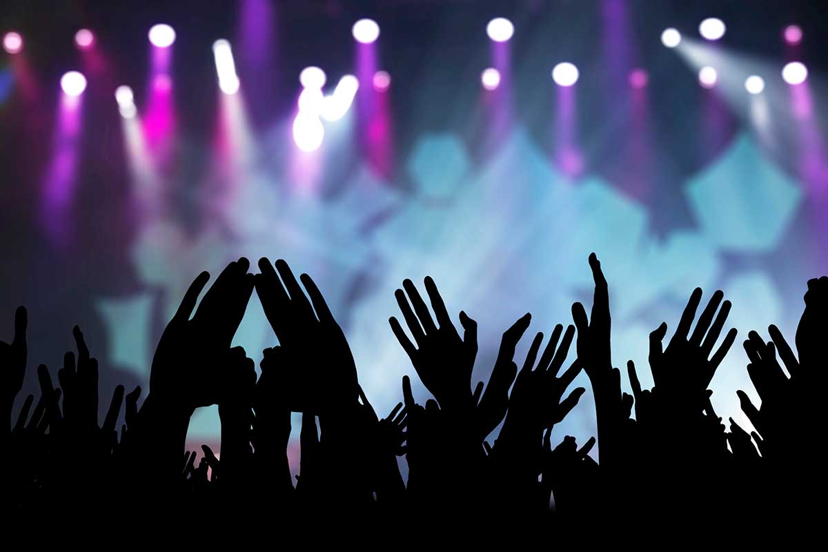 Fans raising their hands at a concert in Berlin, Germany.