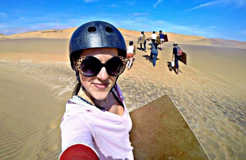 Sandboarding the dunes when traveling Namibia