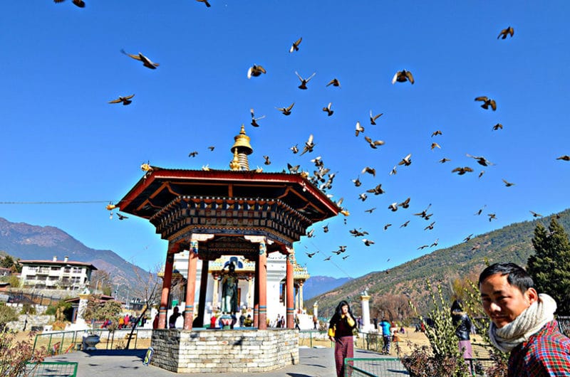 bhutan tour guide at a pagoda 
