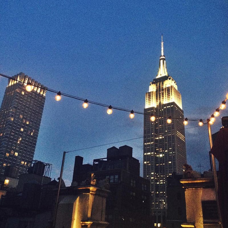 See New York at night time including the Empire State Building from Refinery Rooftop deck