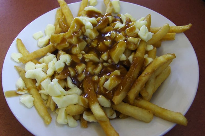Eating poutine during a trip to Canada