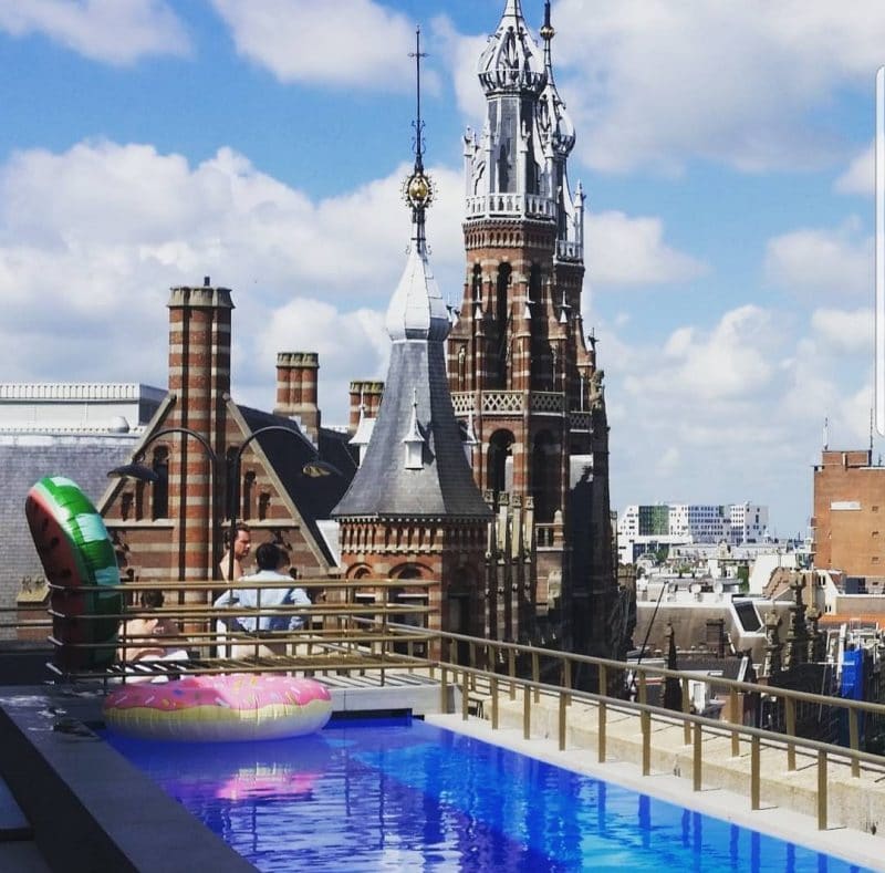 Enjoying the views from the rooftop of the W Hotel on a solo trip to Amsterdam