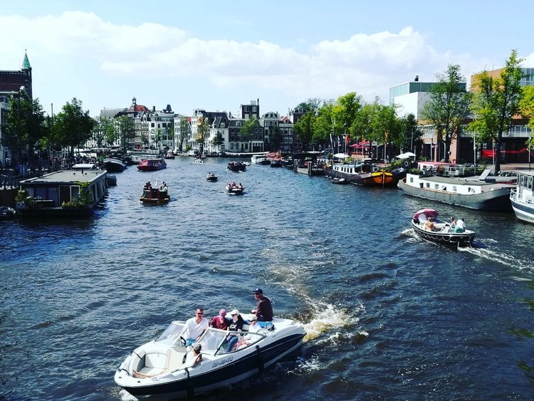 Sailing on the Amstel Canal during solo travel to Amsterdam