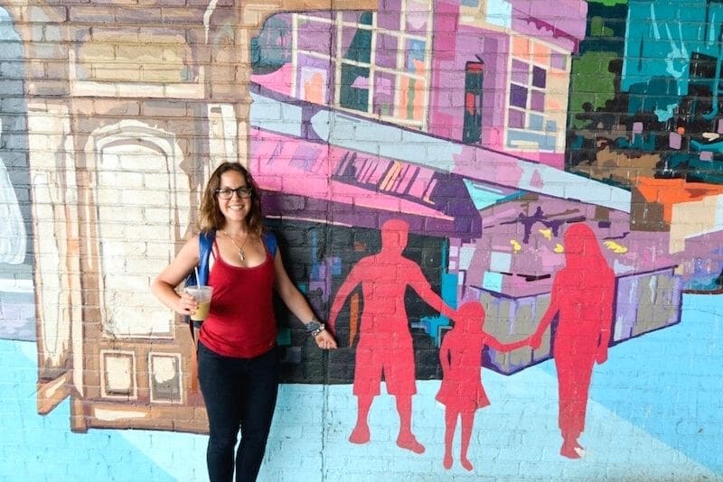 woman posing with street art in Downtown Brooklyn on a walking tour