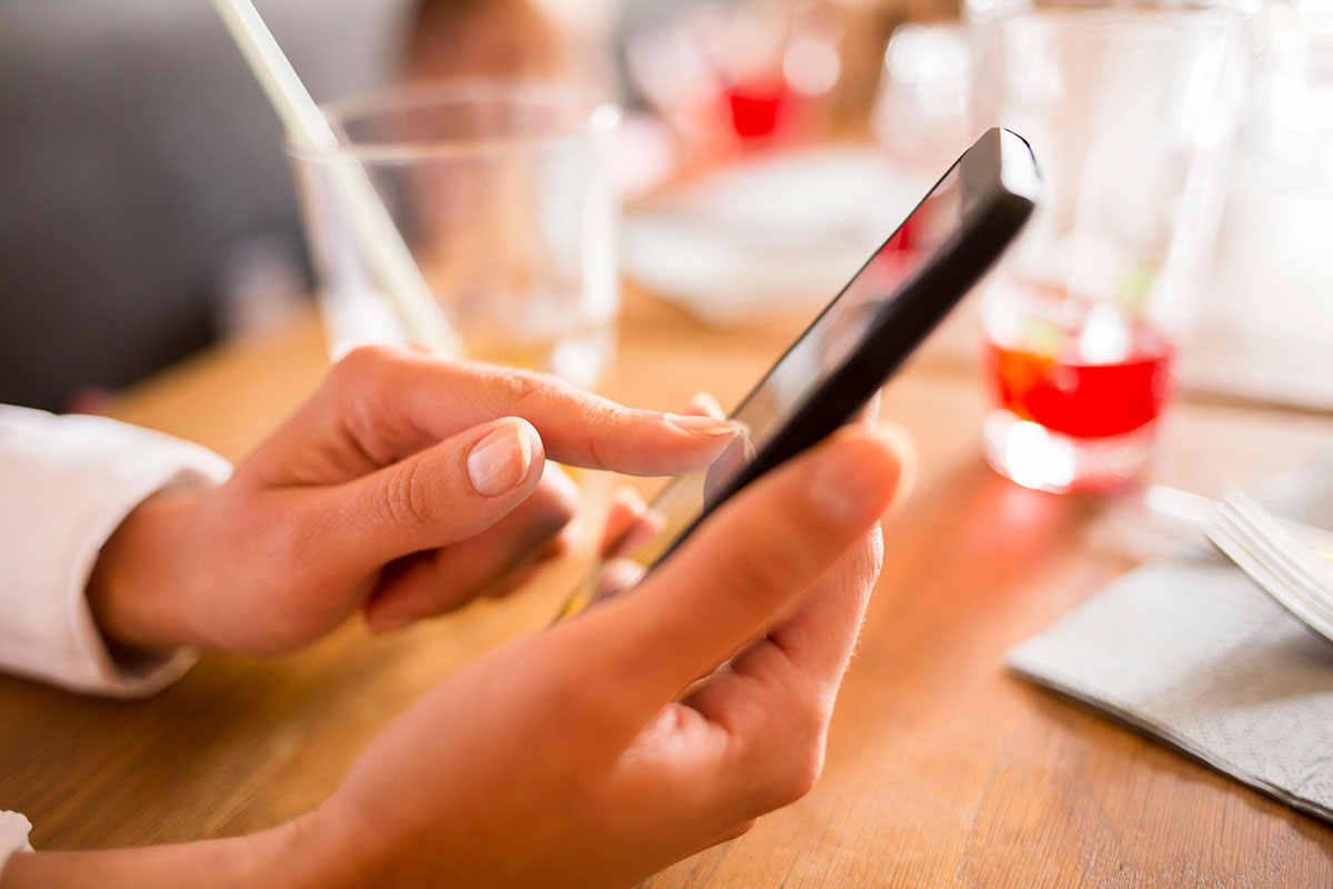Close up of hands woman using her cell phone.