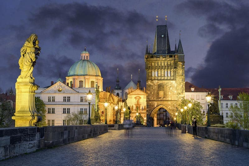 Visiting the Charles Bridge at night on a solo trip to Prague