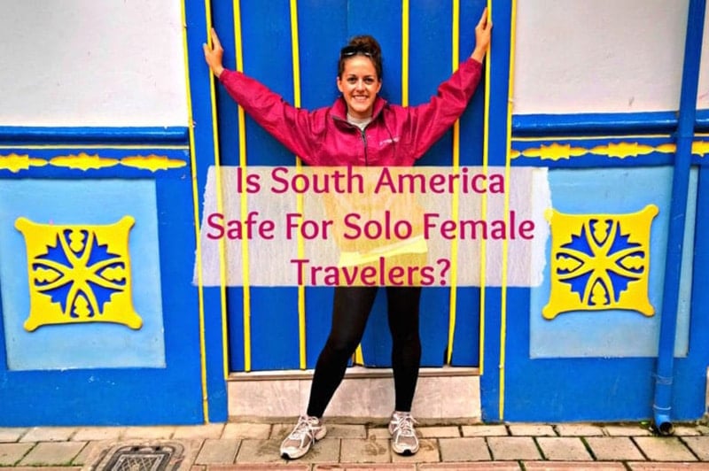 female traveler posing in front of colorful buildings while backpacking South America