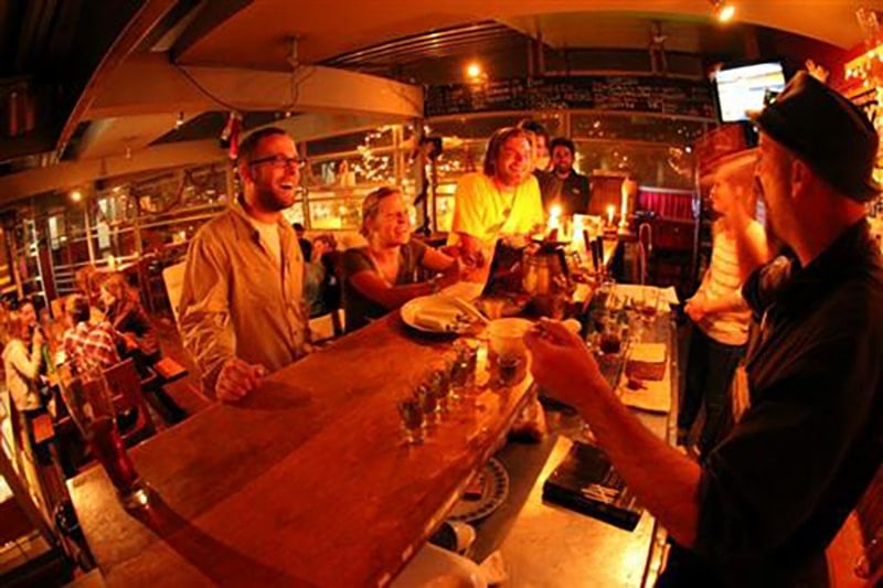travelers drinking at the bar of The Adventure Brew B&B In La Paz, Bolivia