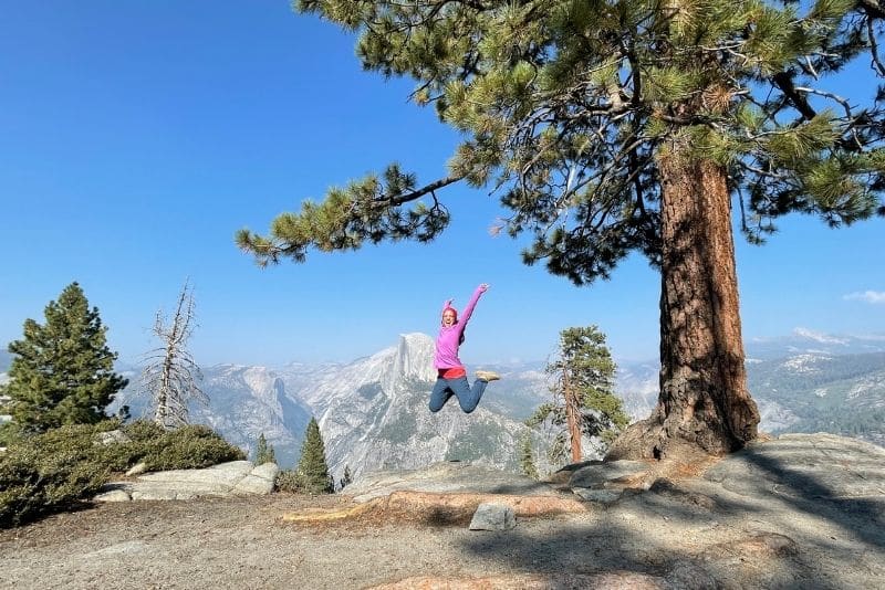 Jumping for joy at Glacier Point with Half Dome in view