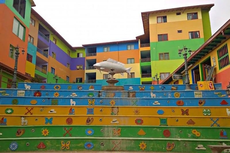 walking up a multi-colored staircase while traveling Colombia 