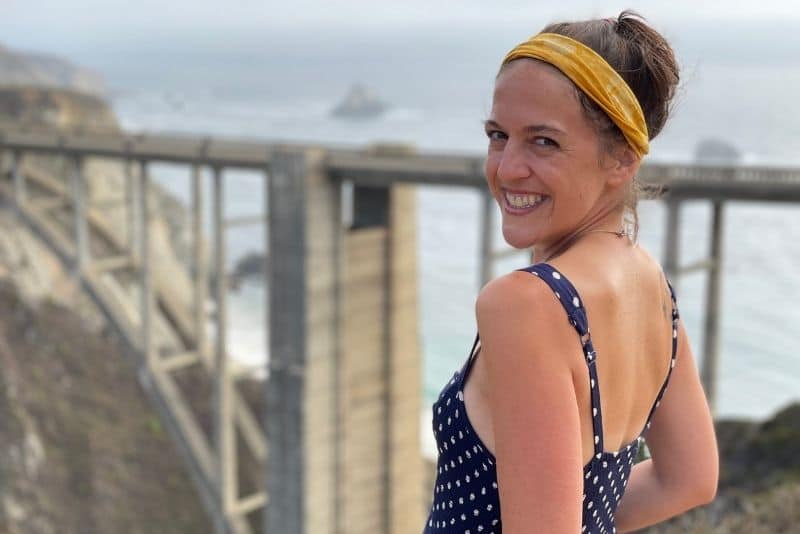 woman enjoying solo female travel in California in Big Sur at Bixby Bridge