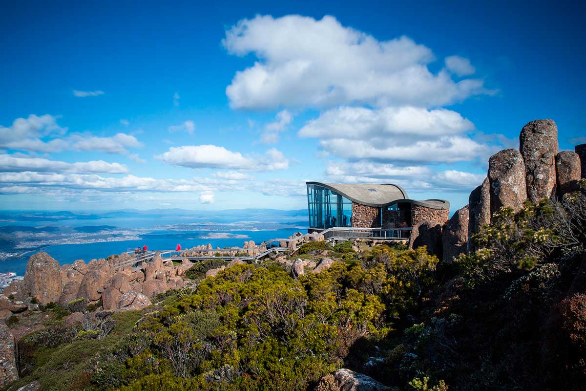 A landscape of the Mount Wellington summit under a blue cloudy sky in Tasmania, Australia