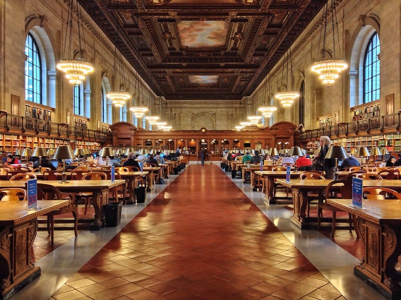 People reading books in the New York Public Library Reading Room, one of the top places to go in NYC by yourself