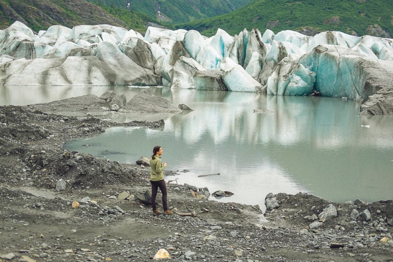 Woman visiting Spencer Glacier in Anchorage, Alaska - one of the best places in the US to travel solo 