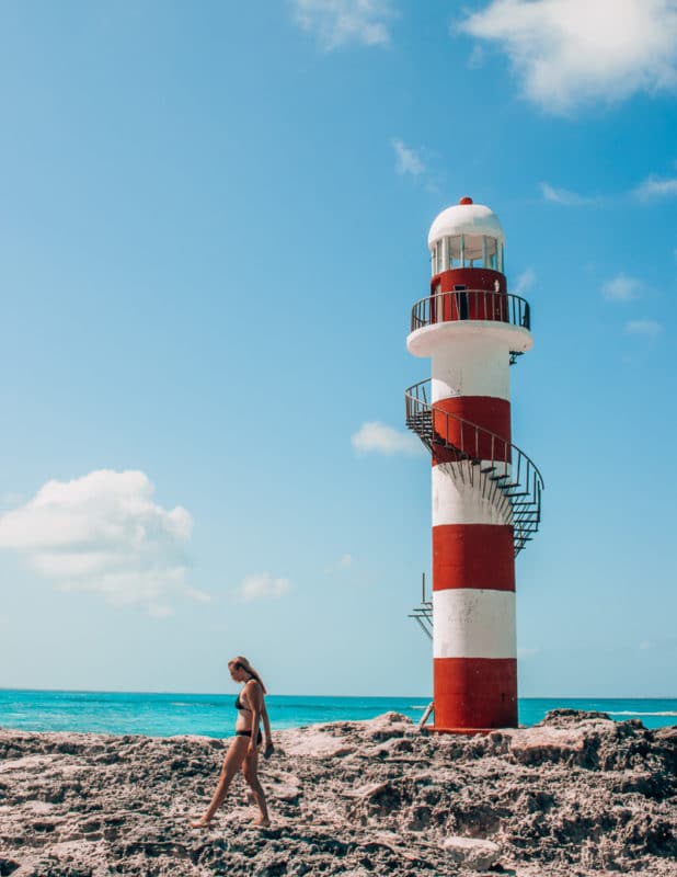 woman traveling alone in Mexico and exploring the Cancun Lighthouse