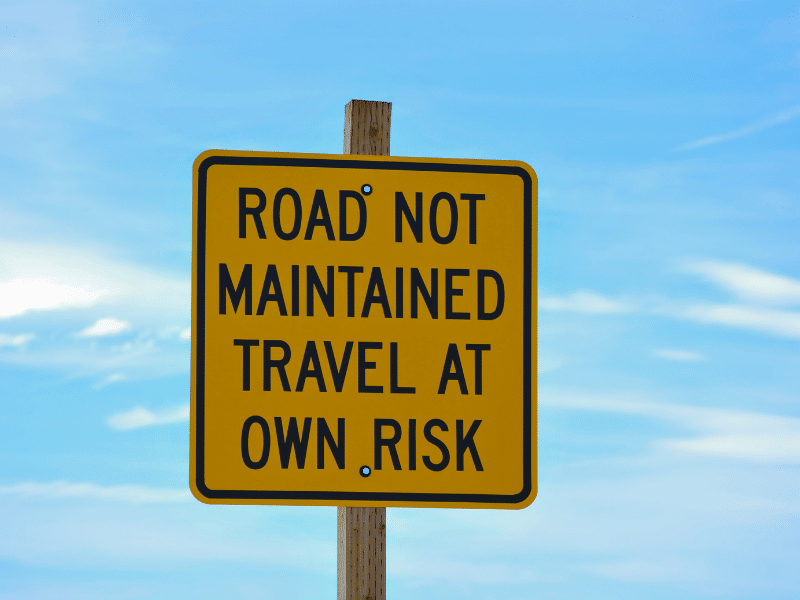 yellow travel solo at your own risk sign