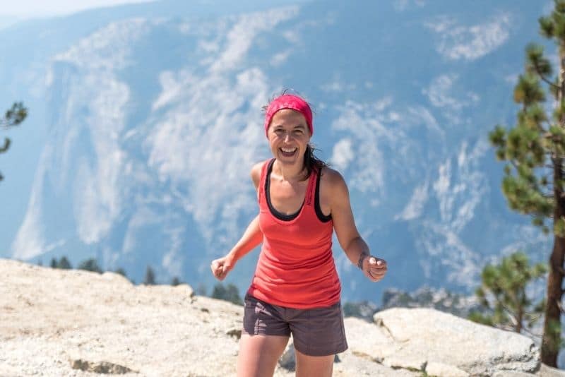woman hiking alone on the top of Sentinel Dome in Yosemite National Park