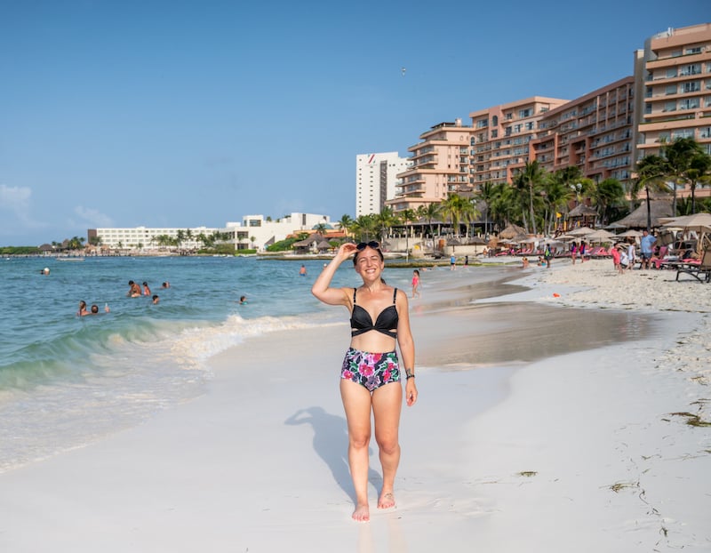 woman walking the beach during a 7 day Cancun itinerary