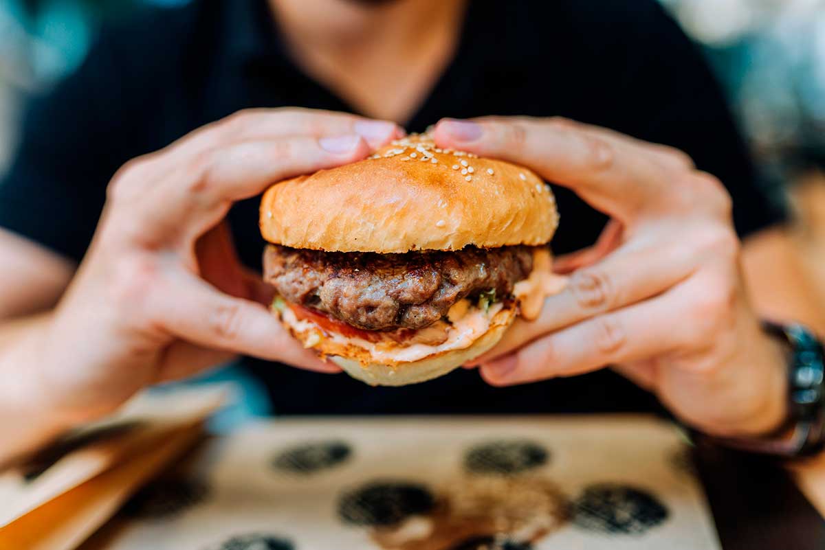 eating a burger at the Queens Night Market after midnight in NYC