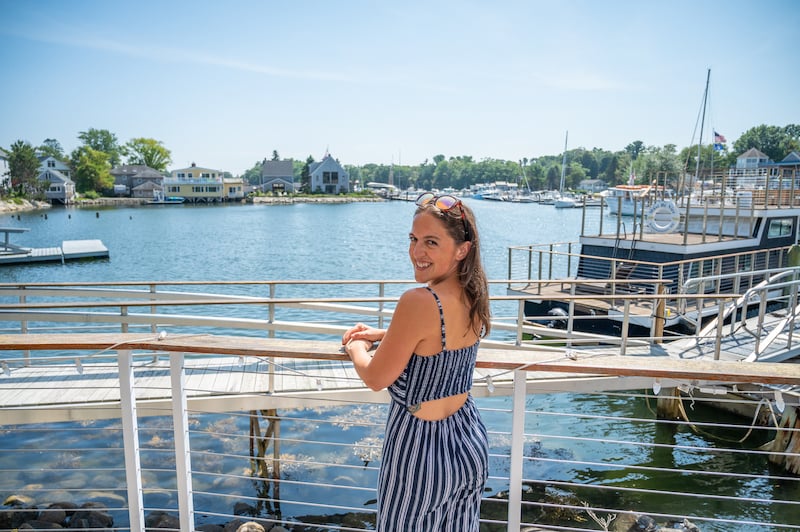 woman in front of the water in Kennebunkport on a road trip through Maine