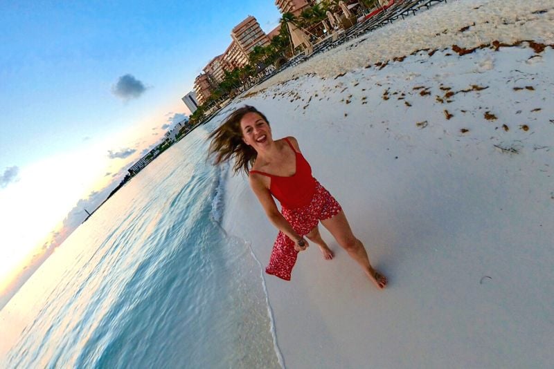 woman running on the beach while traveling solo in Mexico