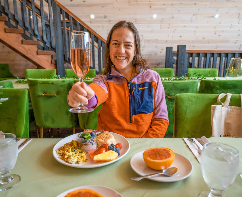 woman eating breakfast and mimosas at Gilbertsville Farmhouse