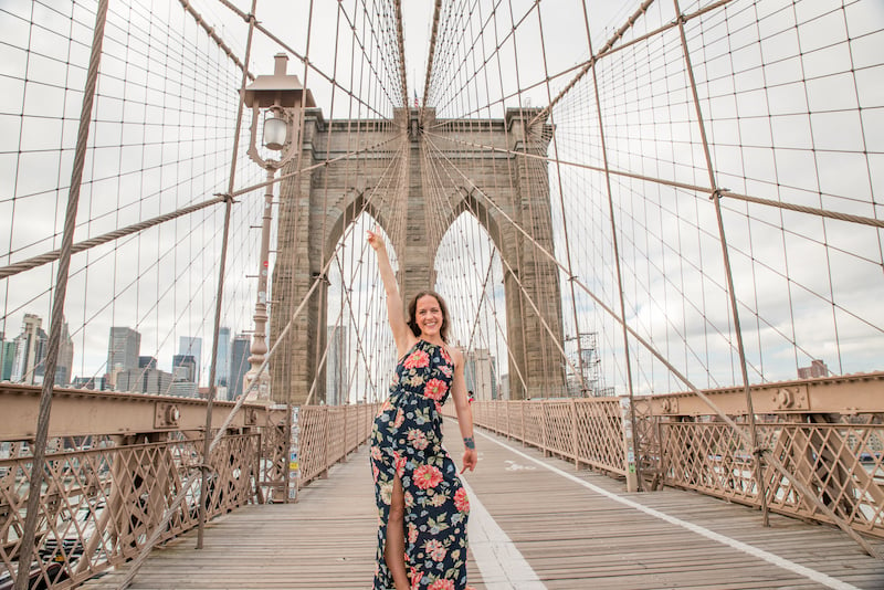woman posing on the Brooklyn Bridge  during a food tour in Brooklyn