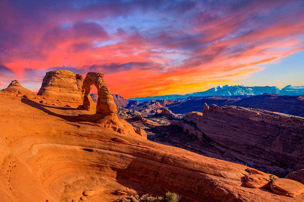 sunset over a valley in Arches National Park