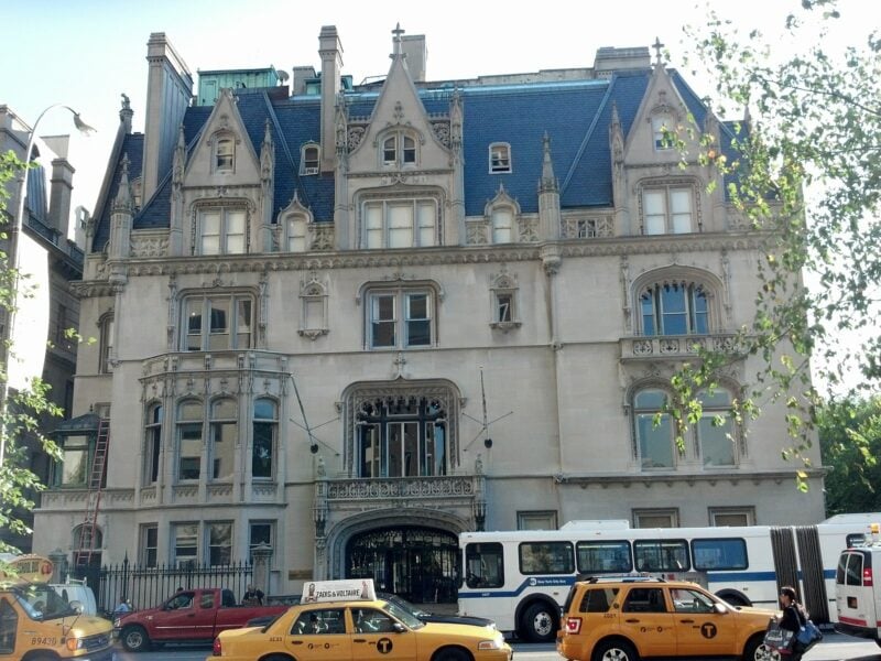 Gilded Age mansion with yellow taxis out front on the Upper East Side of New York City