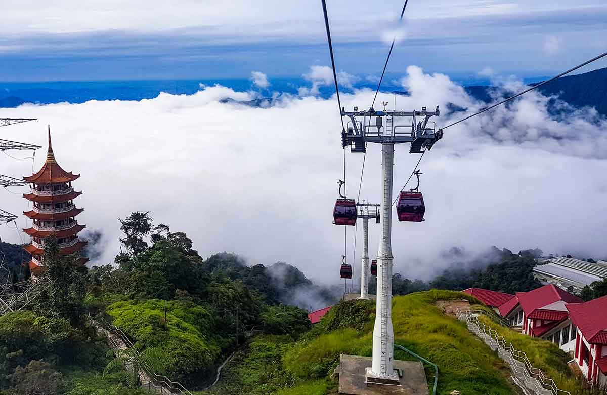 red cable cars moving up the hills of the Genting Highlands in Malaysia