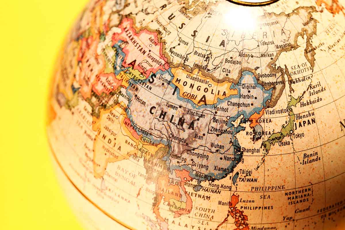 Close-up of a vintage world globe showing East Asia, including China, Mongolia, and Japan.