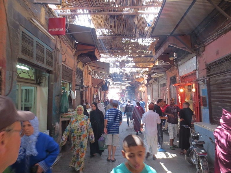wandering the busy souks in Marrakech while traveling alone in Morocco 