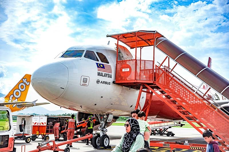 A close up photo of the front of a plane in Malaysia.