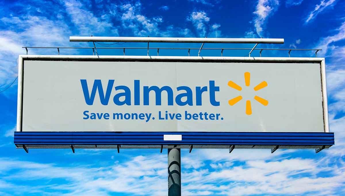 Walmart billboard displaying the slogan “Save money. Live better.” against a blue sky.
