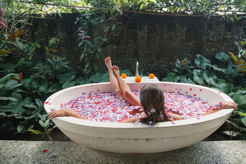 woman relaxing in a Balinese flower bath in Ubud