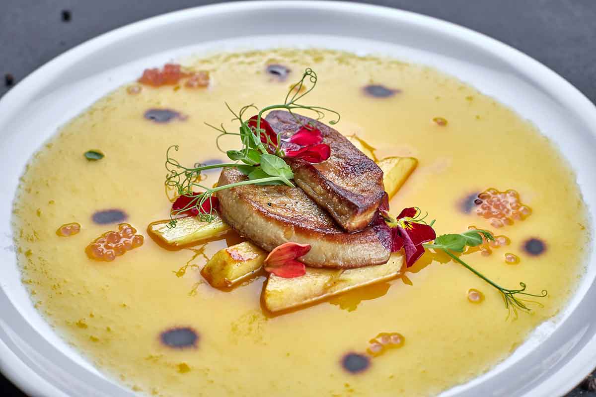 Foie gras with sauce, on a white plate.