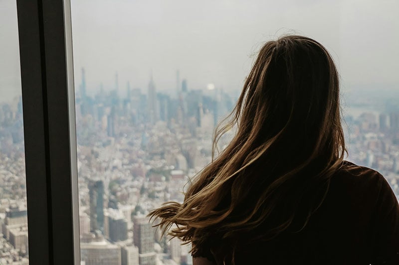 A woman enjoying the NYC views from World Trade Center.