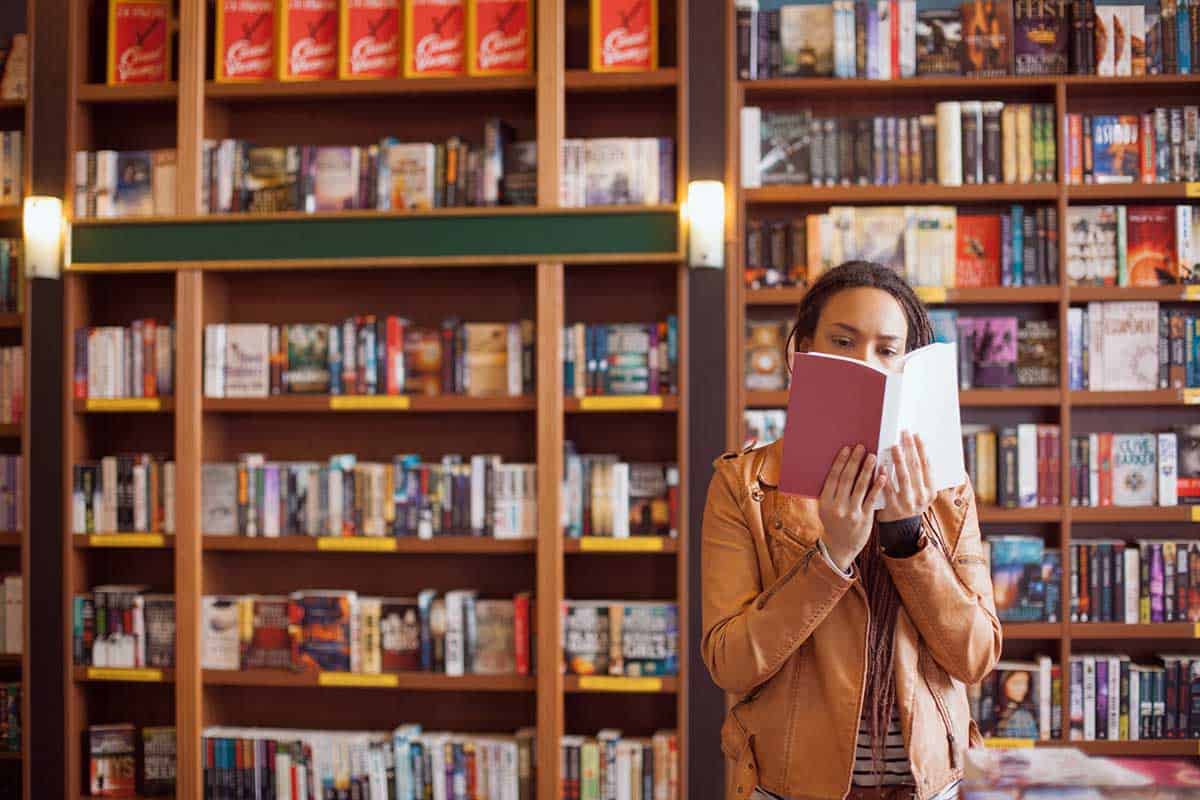 Woman reading a book at a book shop in NYC.