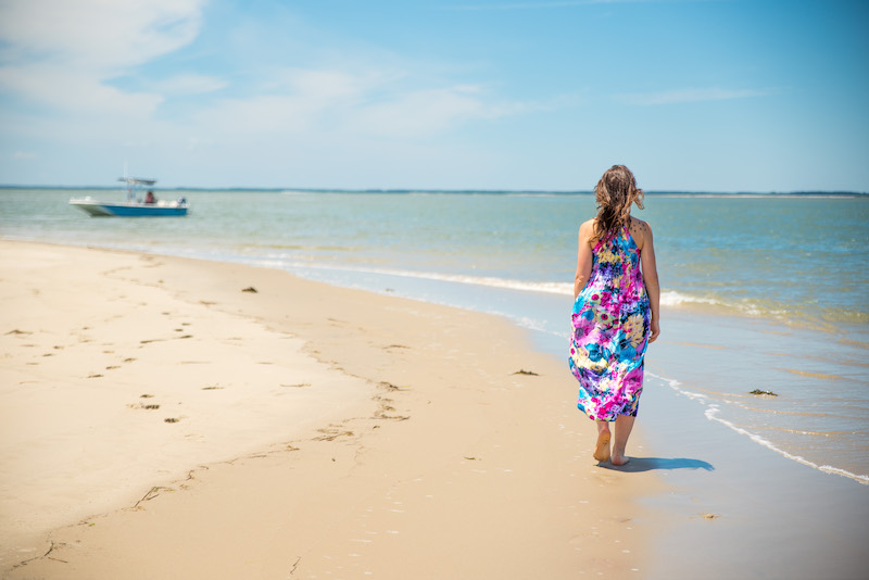 woman walking the beach while traveling solo in the Eastern Shores