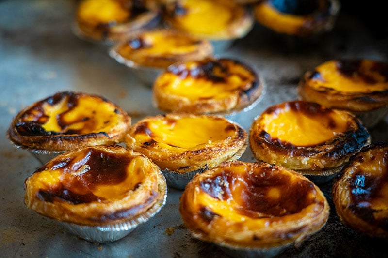 Portuguese egg tart pastries, dusted with cinnamon.