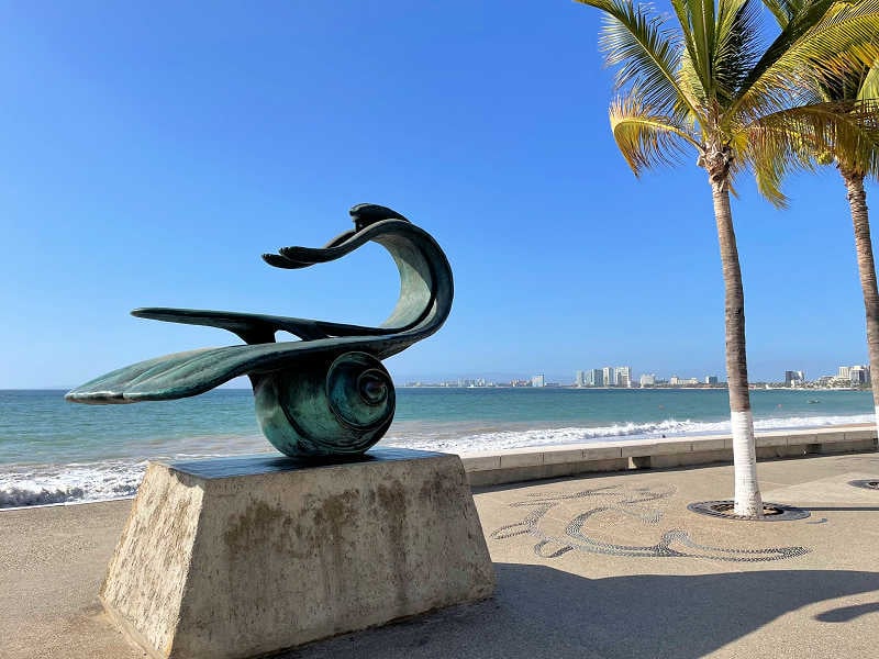 woman seeing the Naturaleza Como Madre sculpture while traveling solo in Puerto Vallarta, Mexico