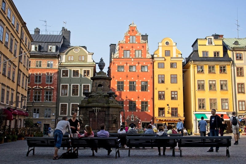 visiting the colorful houses of Gamla Stan while traveling solo in Stockholm