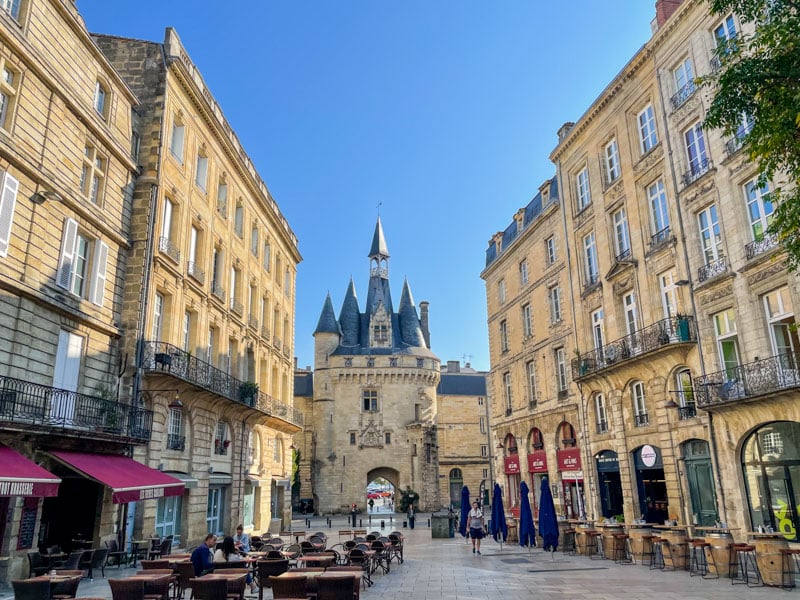 solo traveler in France looking at the yellow buildings of Bordeaux