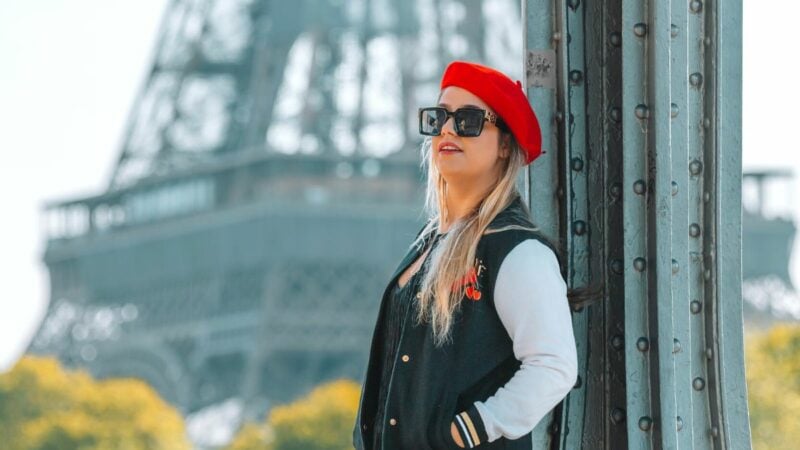 solo female traveler in France posing in front of the Eiffel Tower