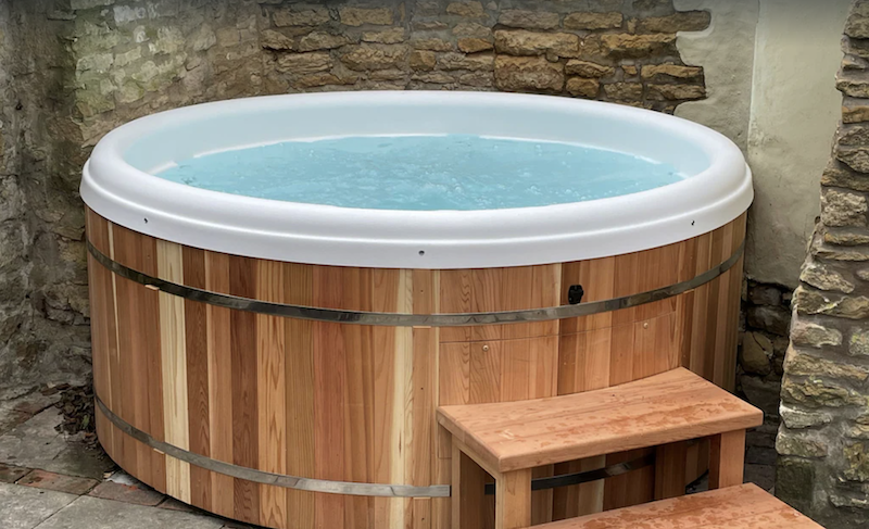 wooden outdoor hot tub filled with water