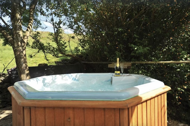 outdoor hot tub with a bottle of Champagne and two glasses