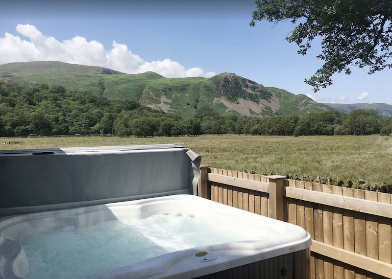 lodge with hot tub in the Lake District with mountains in the background