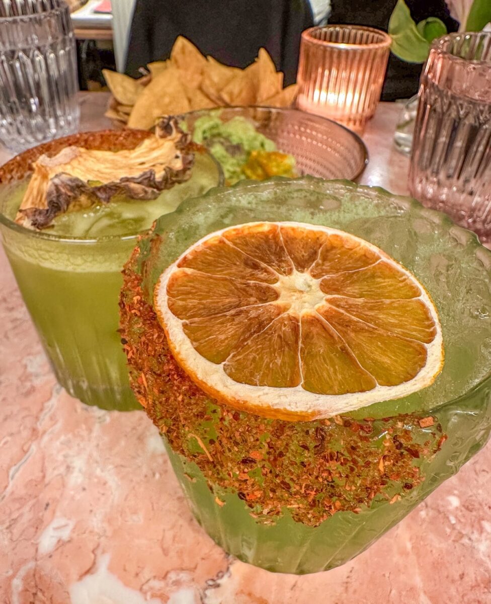 two tequila cocktails next to a plate of homemade guacamole at Soledad Restaurant in the Upper East Side